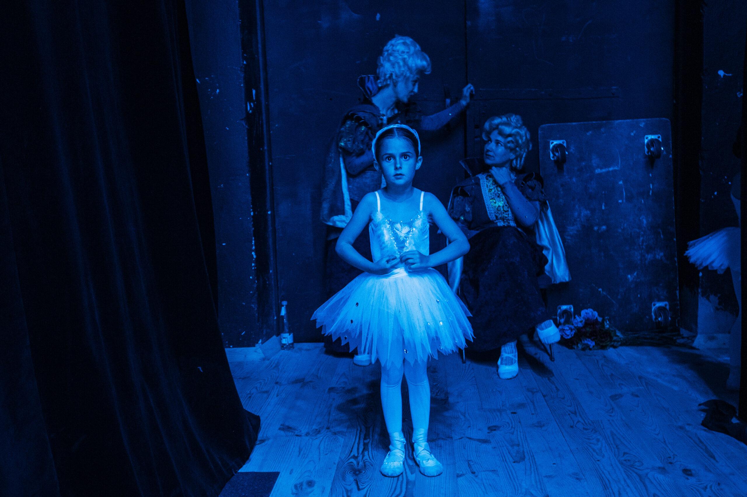 A young ballerina is seen backstage at the rehearsal of "Swan Lake" in Moldova.