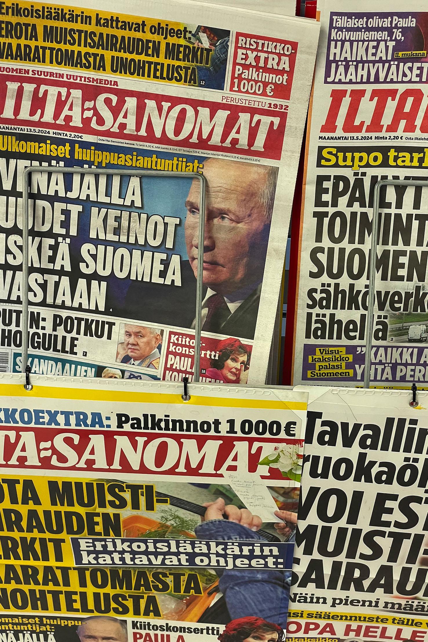 Vladimir Putin is seen on the covers of newspapers, along the Finnish-Russian border in May 2024.