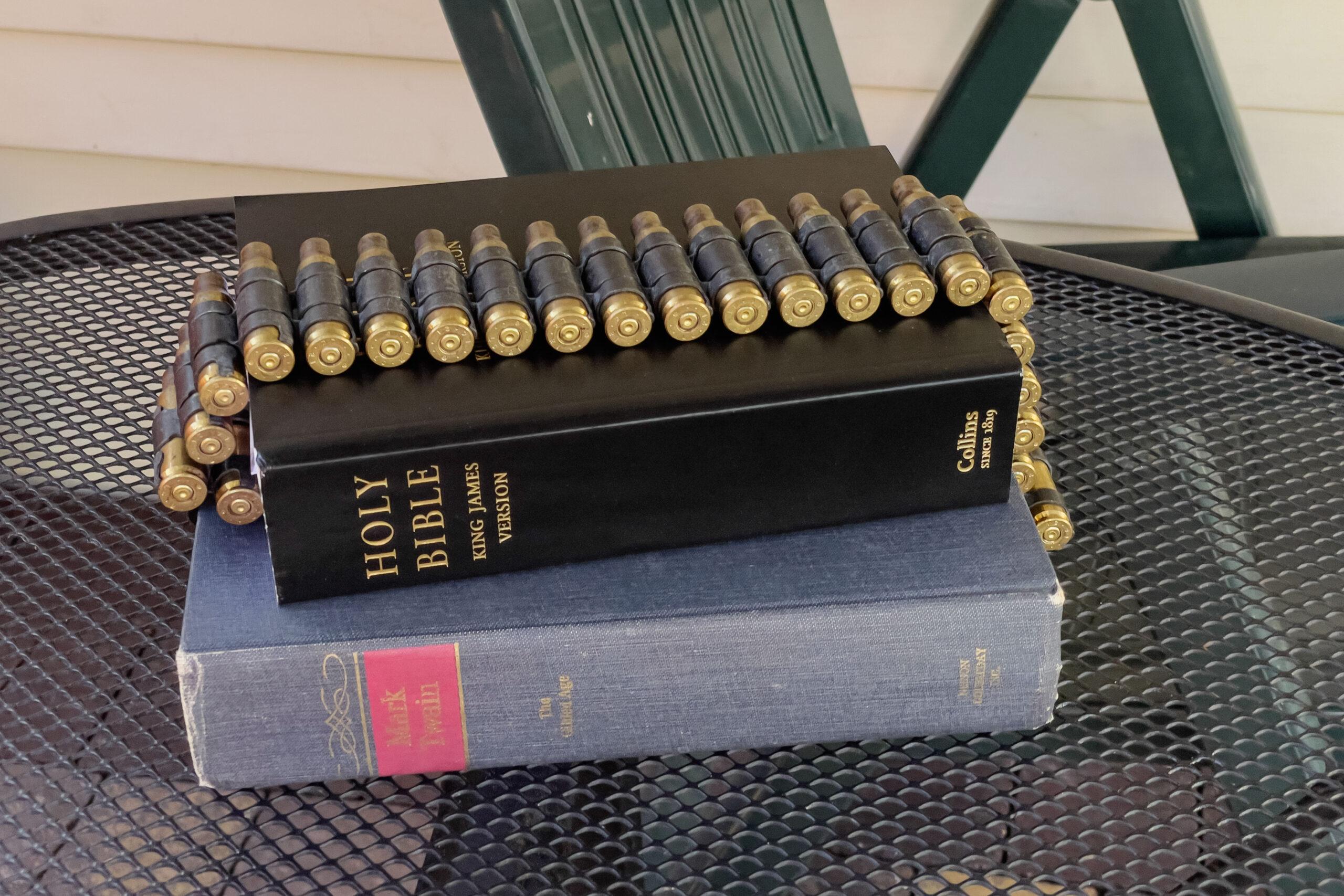 A magazine of bullets is seen draped over a bible, part of a Live Action Role Playing group dramatizing the American dream in Poland.